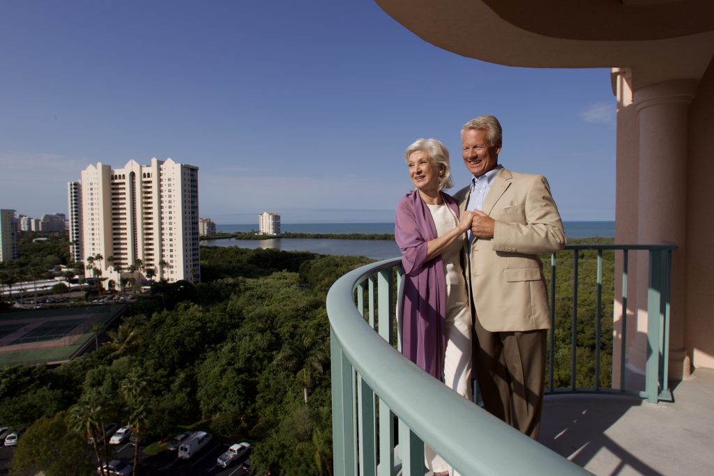 couple on balcony at The Glenview at Pelican Bay in Naples, FL