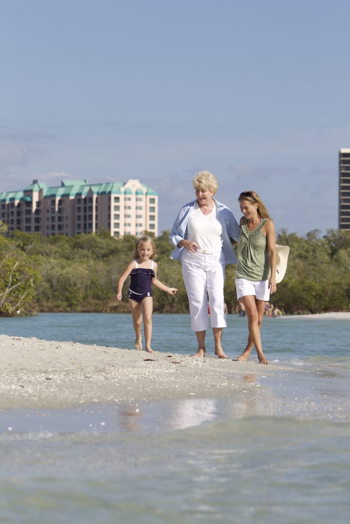 our resident and their family enjoying a walk on our private beach at Glenview Naples