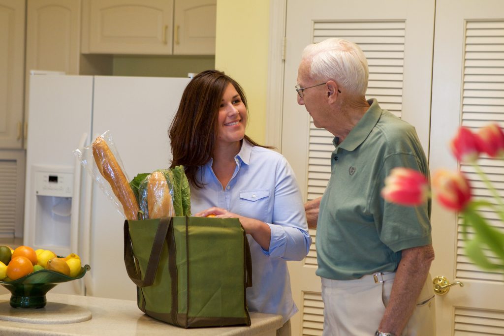 one of our residents grocery shopping for their full kitchen at the Glenview Naples